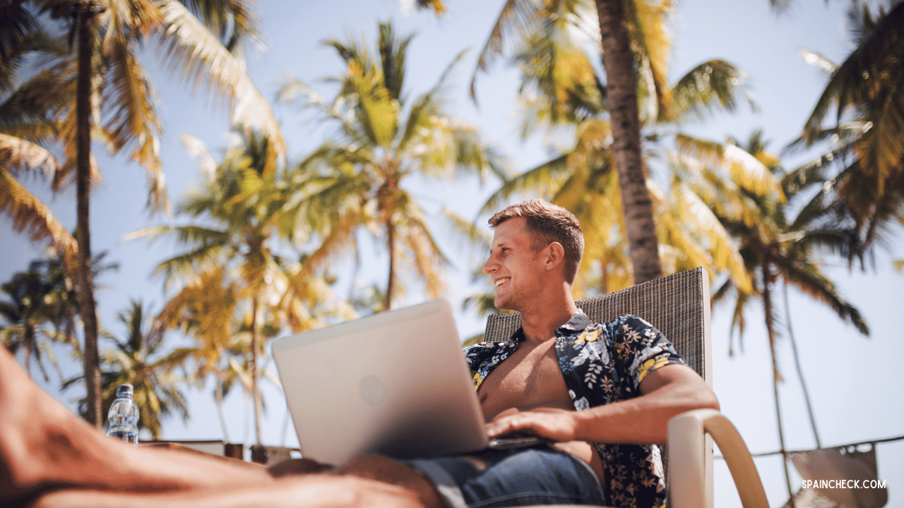 Cover image for the Digital Nomad Visa Guide: A man sits by the pool with his laptop in Spain