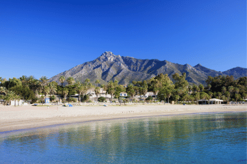 A beach on the Costa del Sol in Spain with La Concha Mountain in the background.