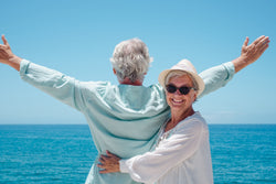 Man and woman in retirement age enjoying a sunny day on the beach