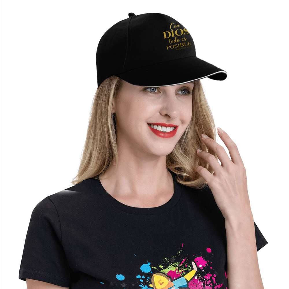 Woman wearing a black cap with text and a black t-shirt with colorful design on a white background