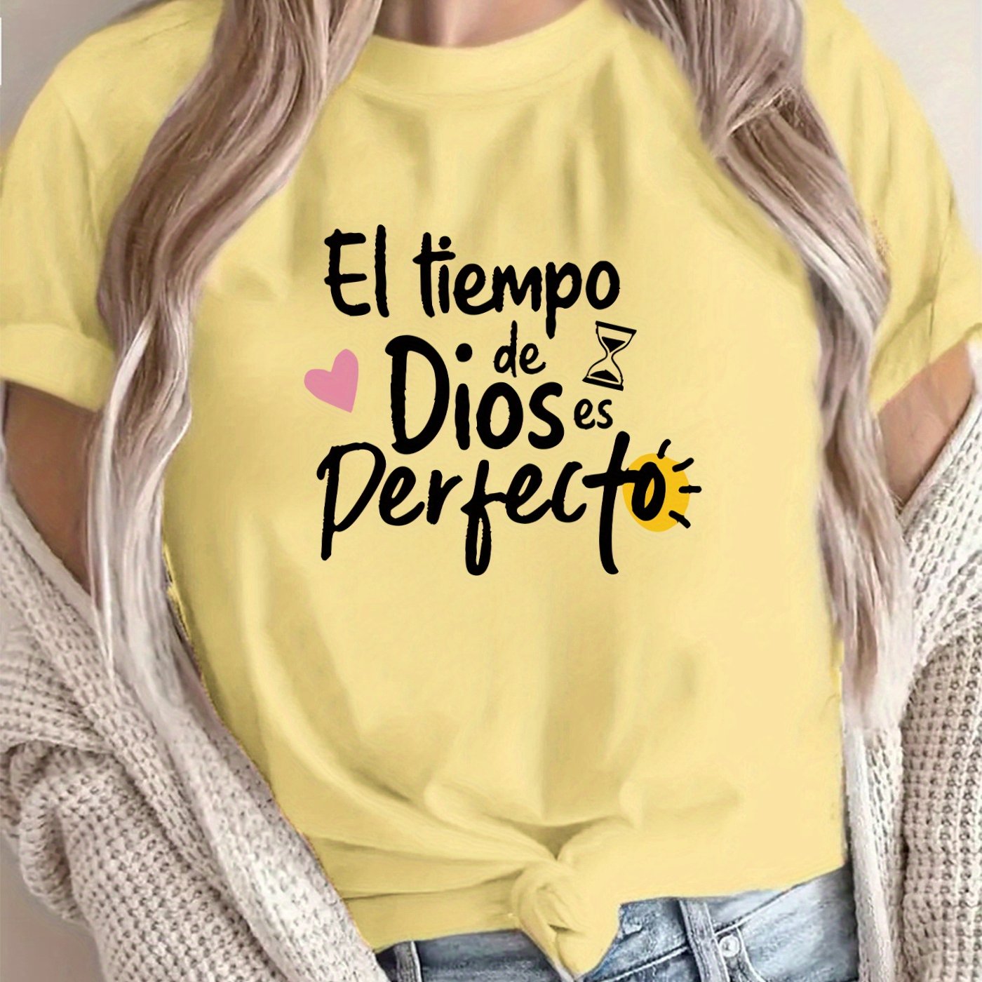 Yellow t-shirt with Spanish text and graphics worn by a person.