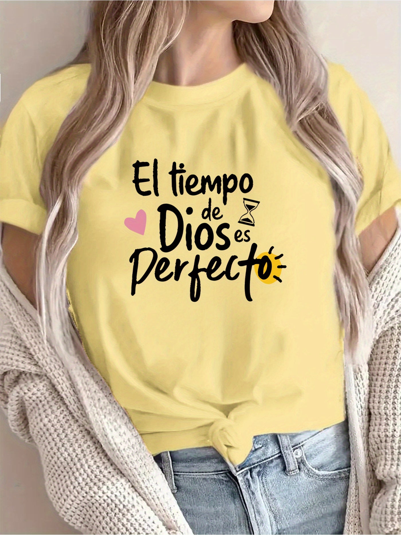 Person wearing a yellow t-shirt with Spanish text and graphics.