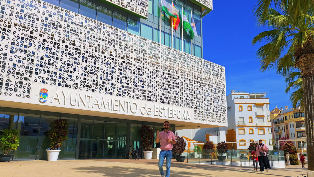 Izidor Isakov standing outside Estepona Town Hall beneath its patterned